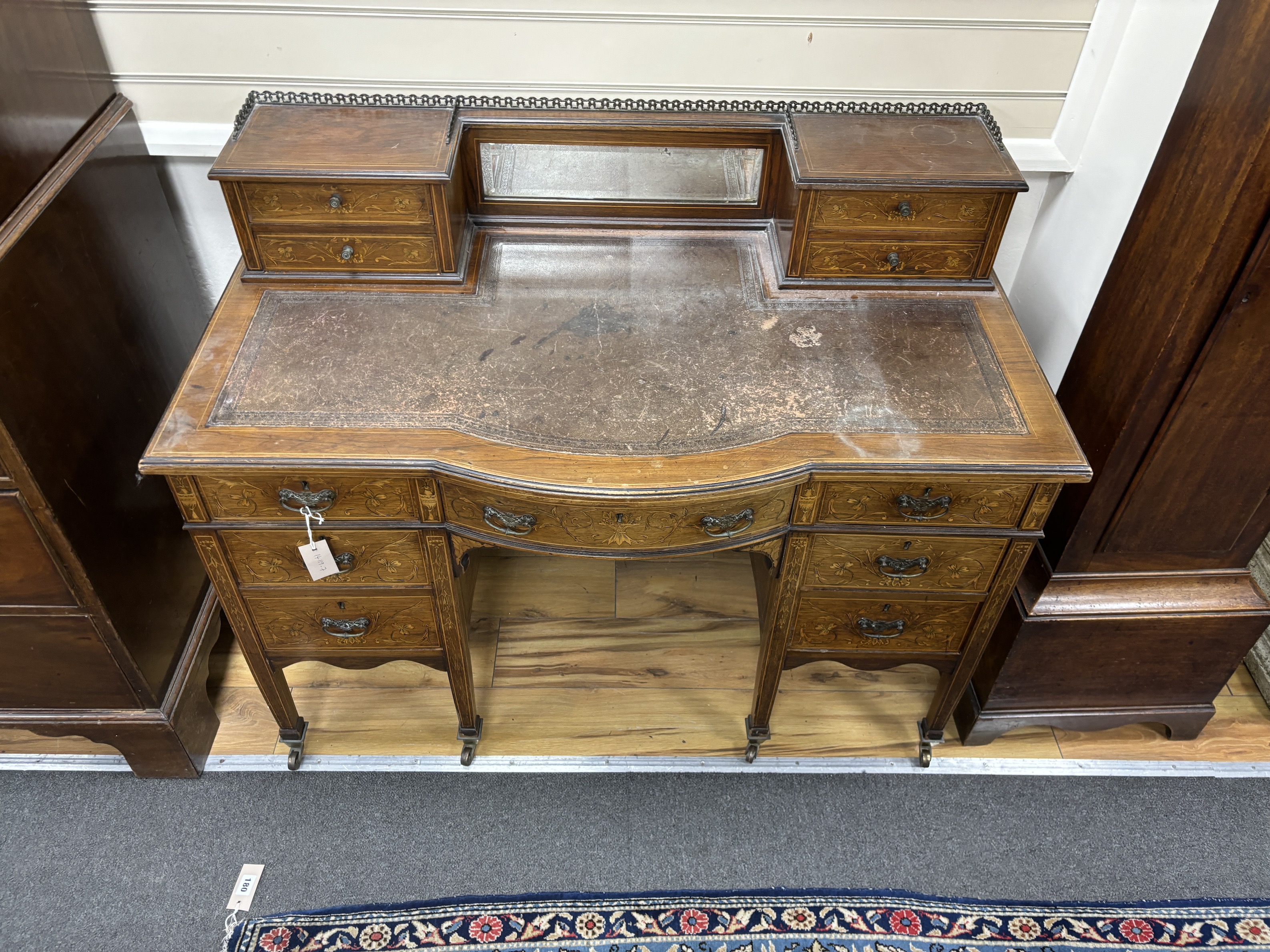 An Edwardian marquetry inlaid rosewood bow front kneehole desk, width 114cm, depth 62cm, height 93cm